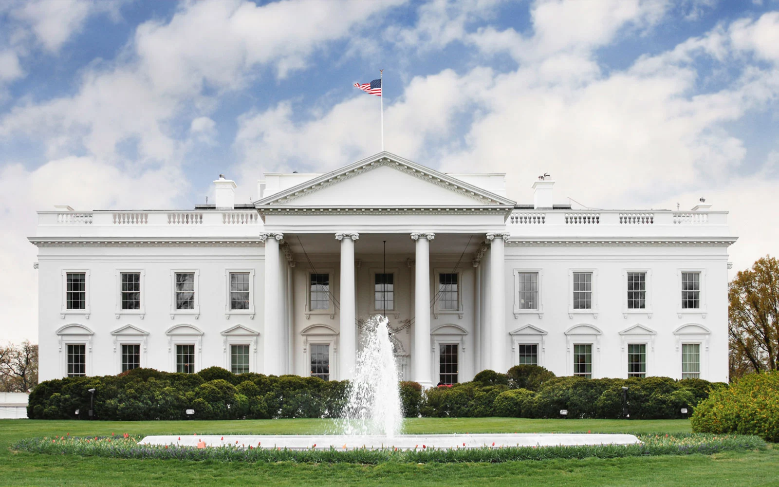The White House with American flag and fountain